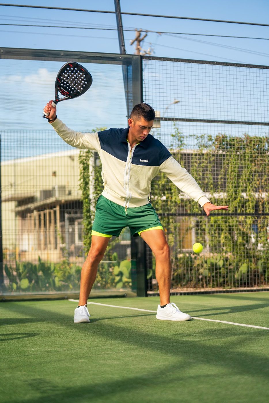 Padel player about to hit the ball on court