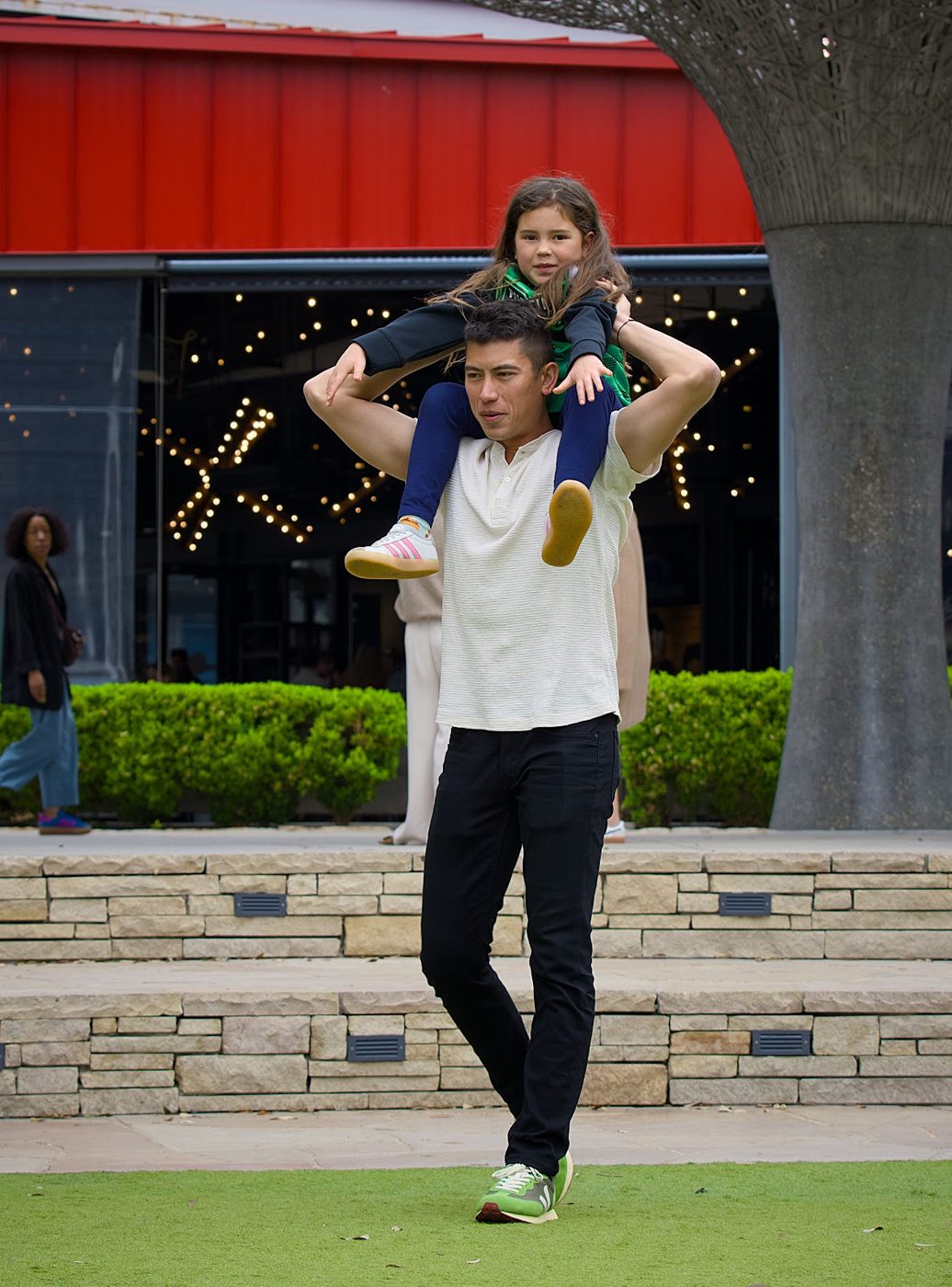 Father carrying his daughter on his shoulders in Austin