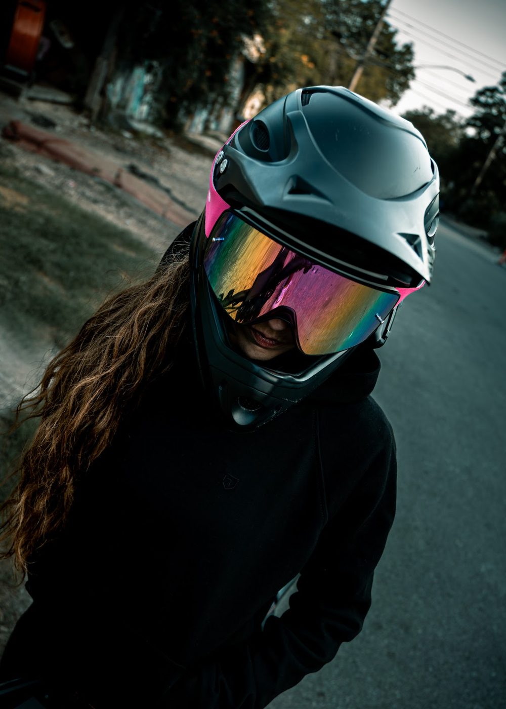 Urban portrait of a motorcyclist with a colorful visor helmet